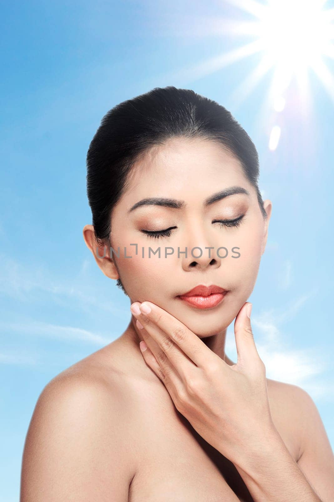 Beautiful face of young adult woman with clean fresh skin over blur background