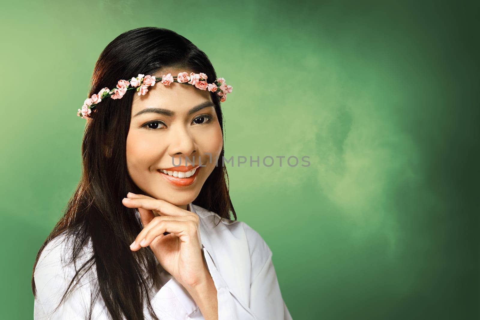 Pretty asian woman wearing flower headband over blur background