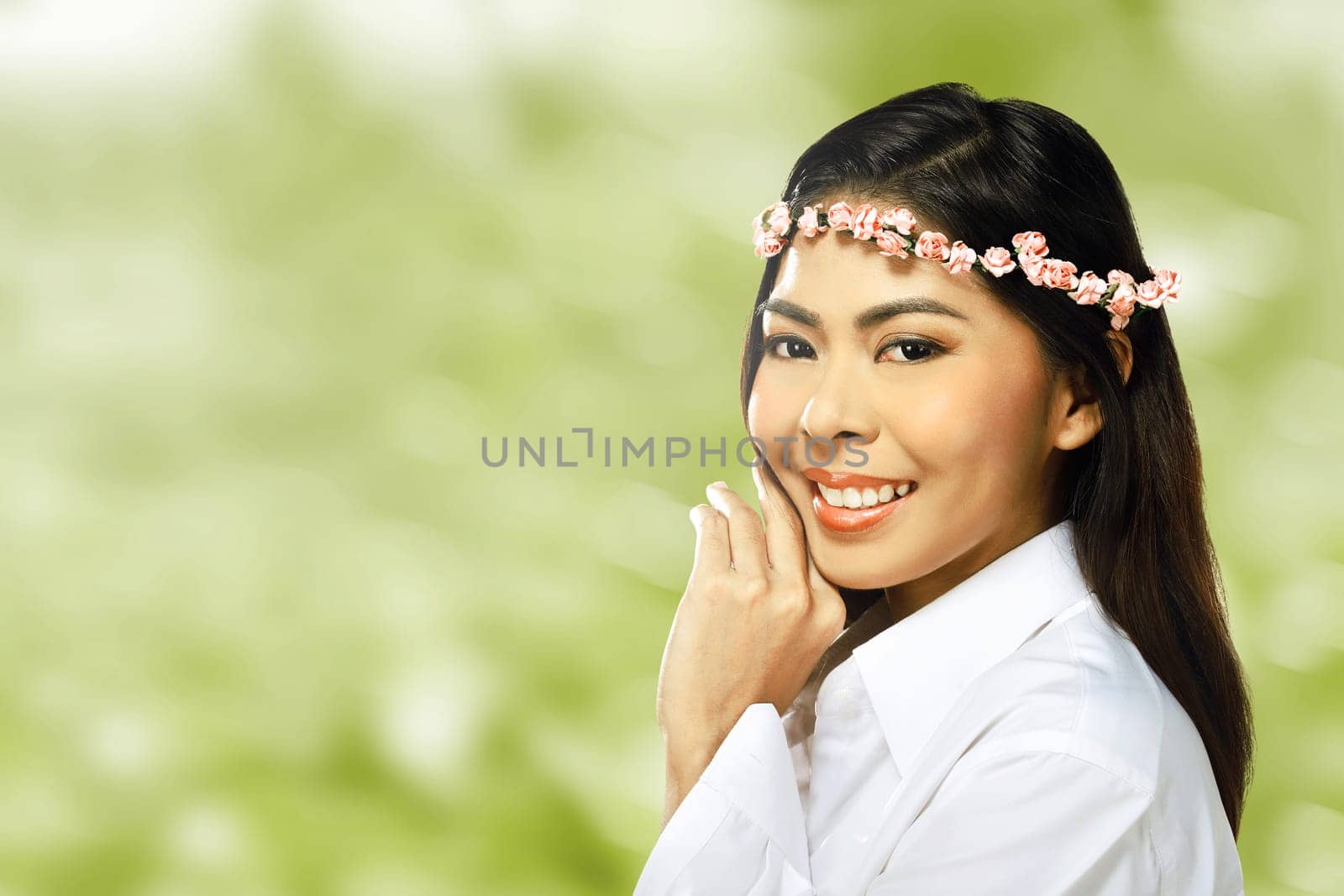 Pretty asian woman wearing flower headband over blur background
