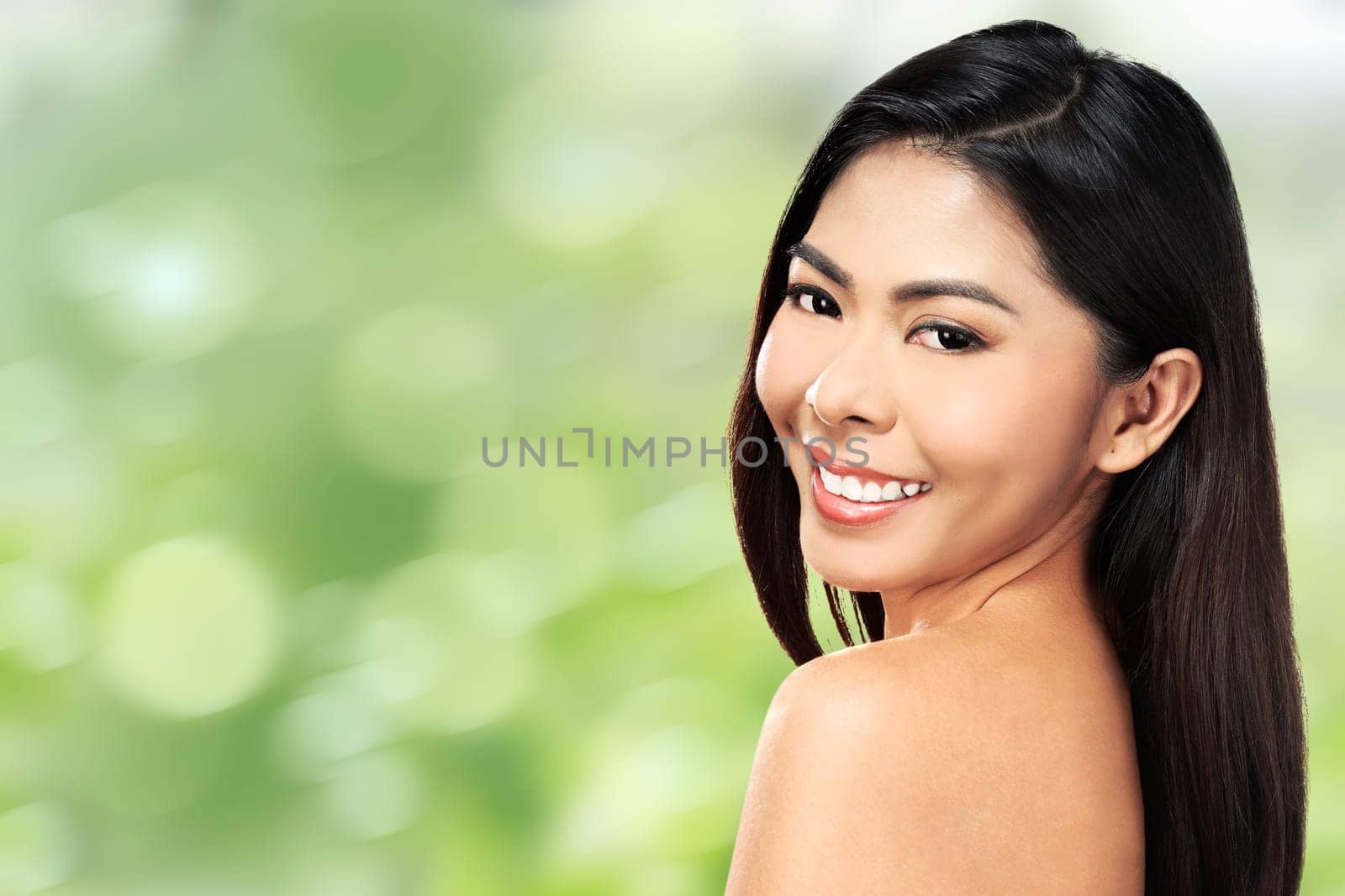 Beautiful face of young adult woman with clean fresh skin over blur background