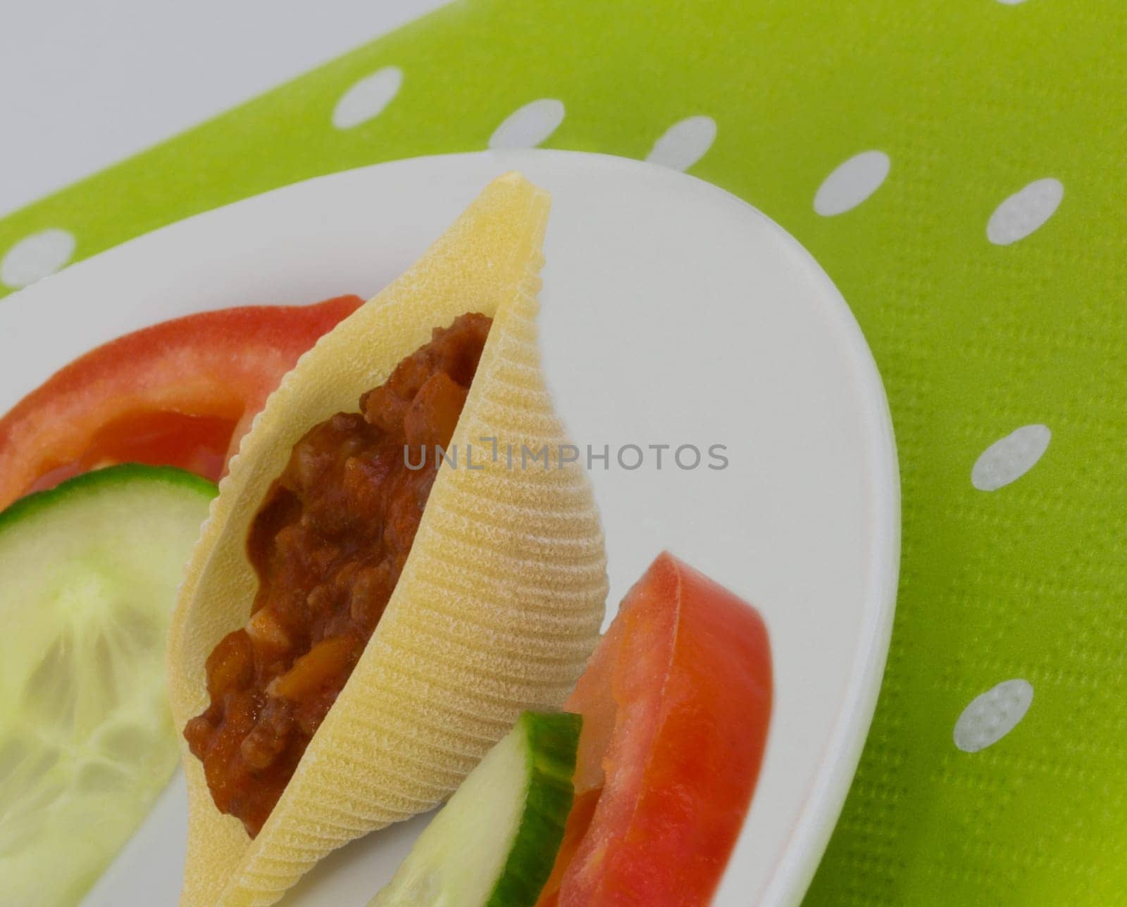 A small snack with tomato and stuffed mussel noodle.