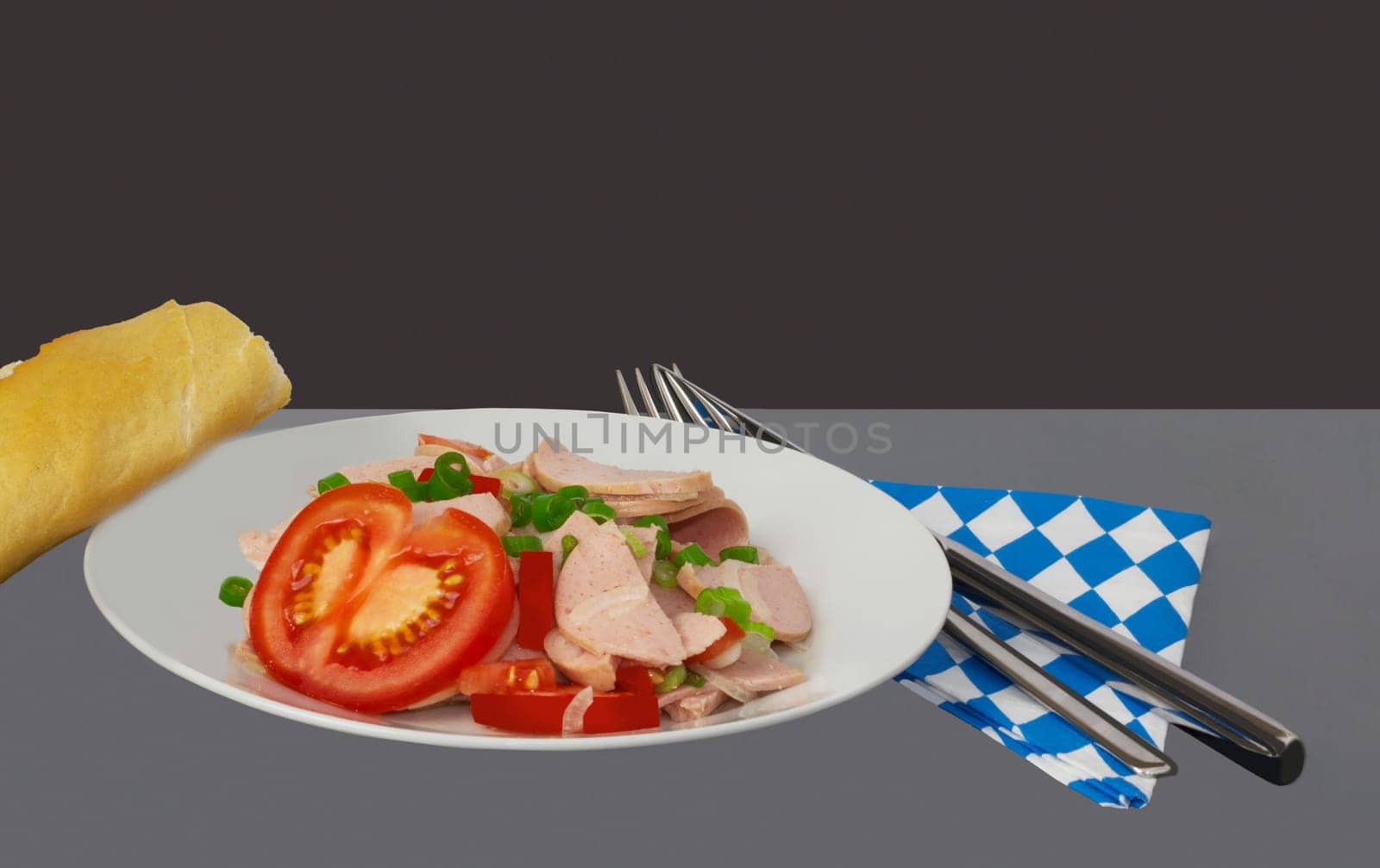 A Bavarian sausage salad is served on a plate.