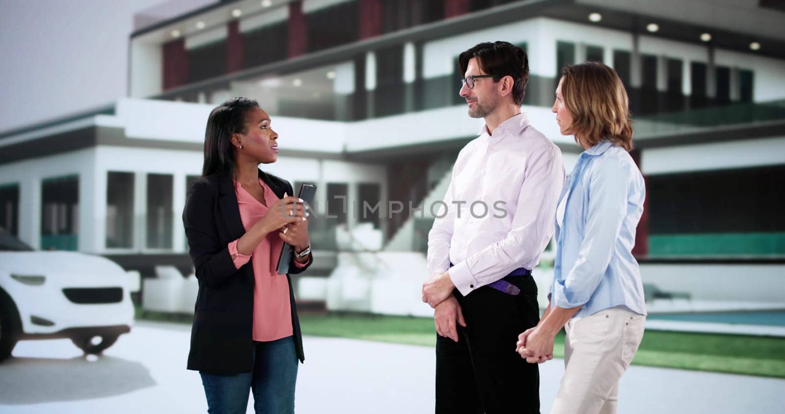 African-American realtor shows diverse couple luxury property for investment upgrade.