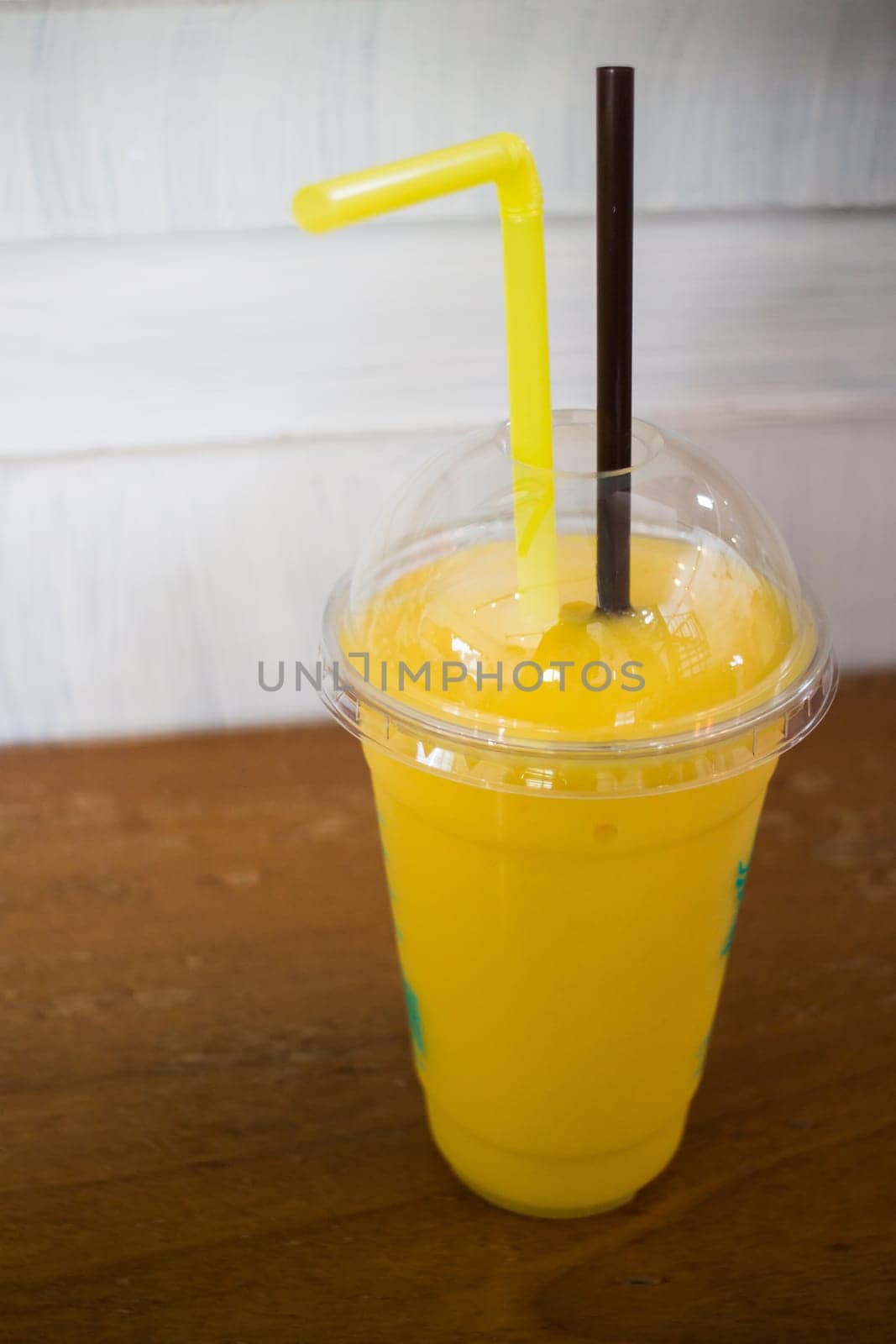Delicious mango smoothies on wooden table, stock photo