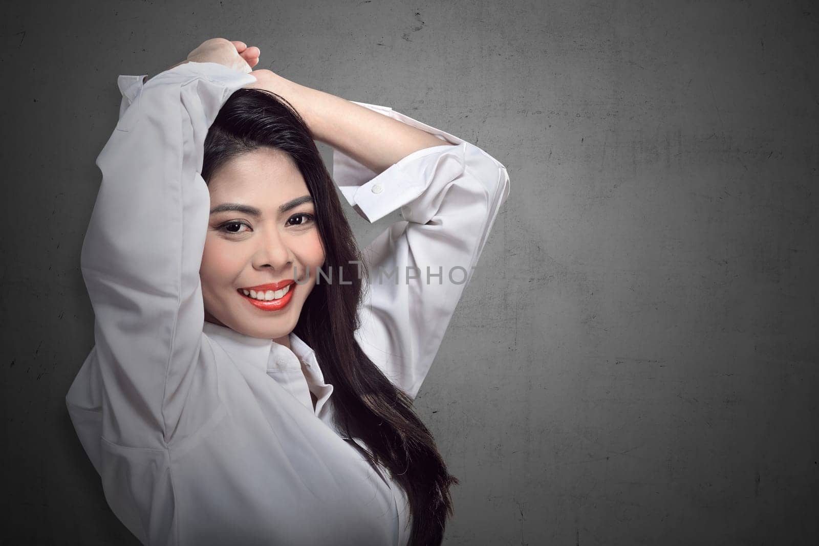 Beautiful face of young adult woman with clean fresh skin over blur background