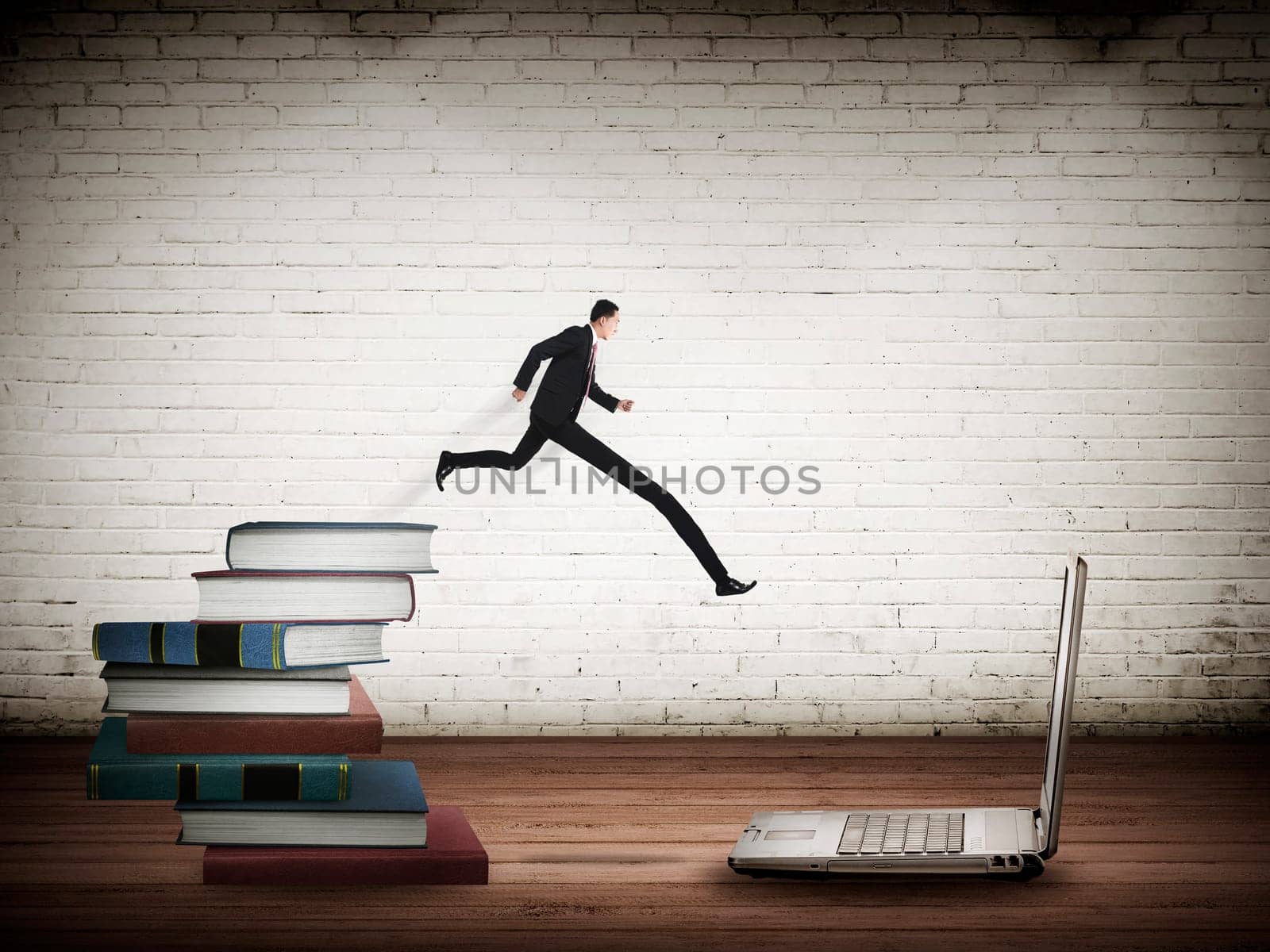 Concept of technology migration with business person jumping from book to laptop