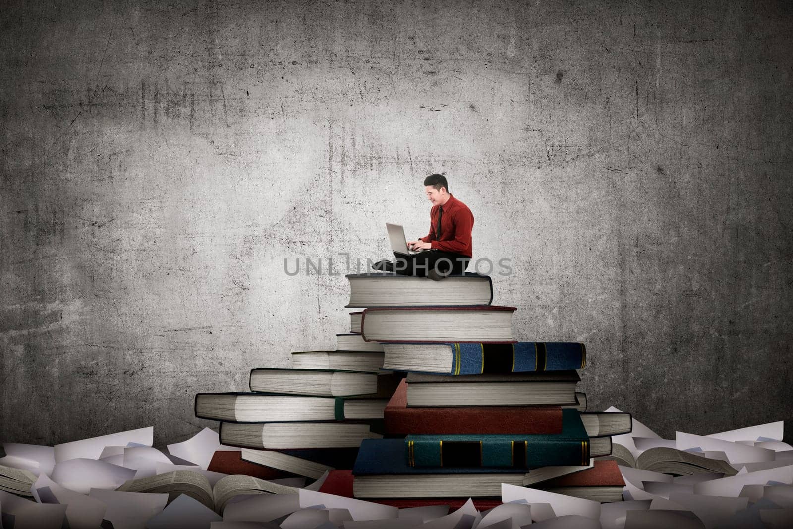 Asian business person working with laptop sit on top of book. Idea and knowledge concept
