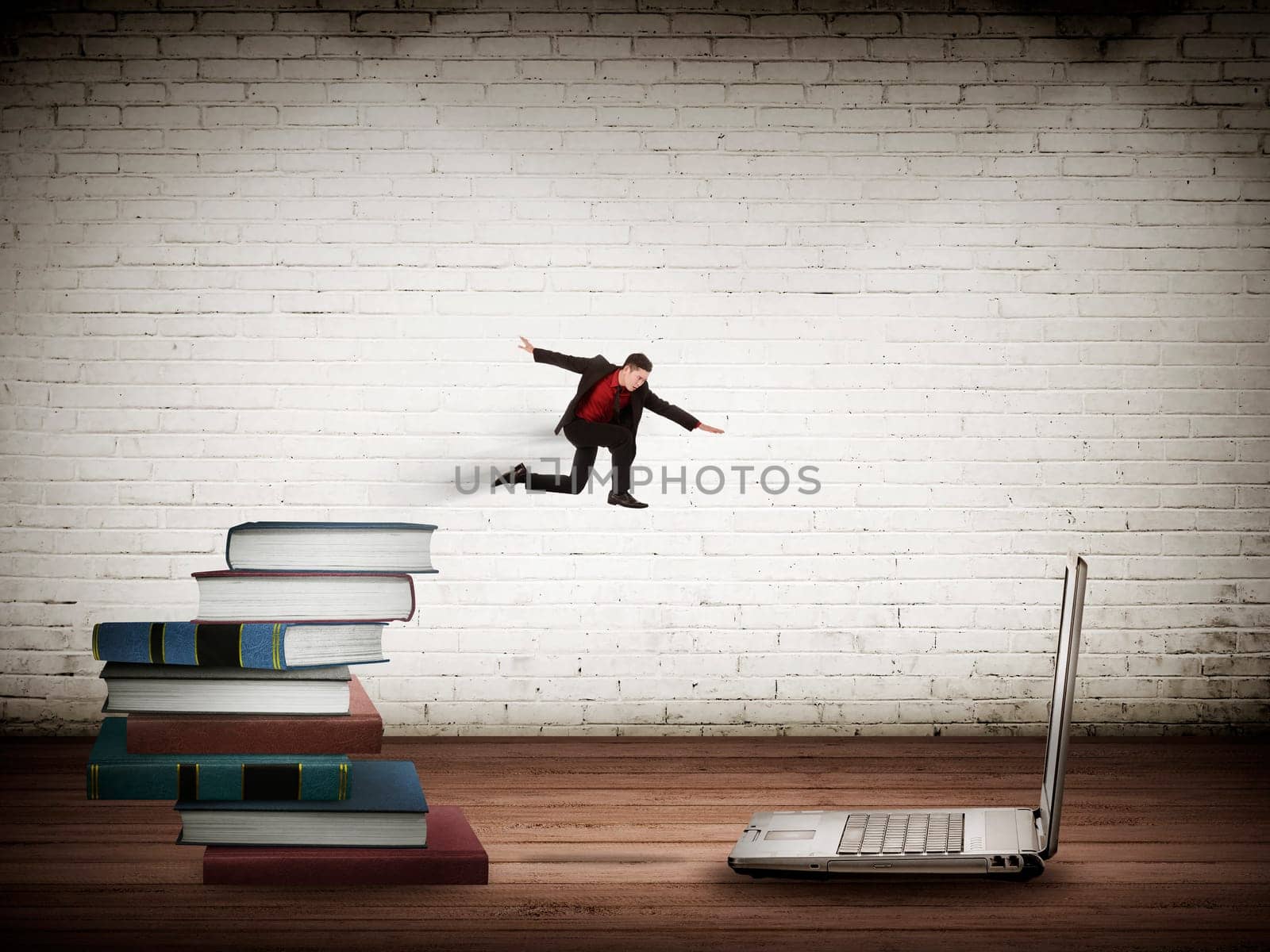 Concept of technology migration with business person jumping from book to laptop