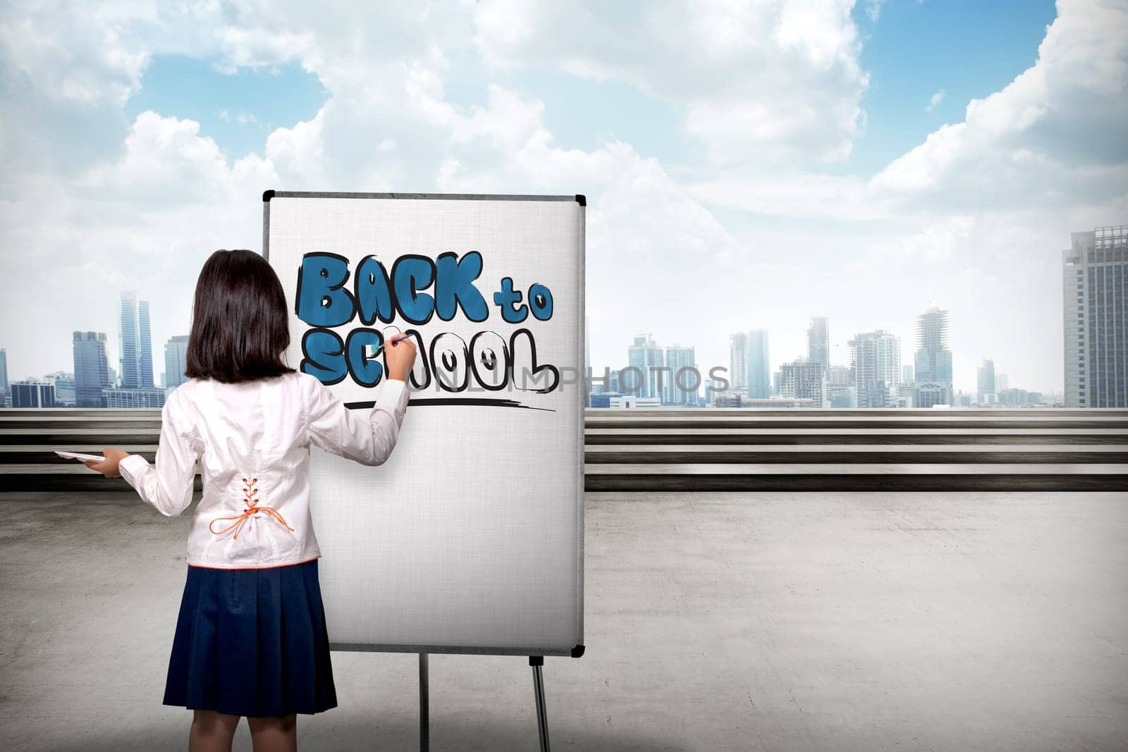 Little girl drawing on canvas back to school writing