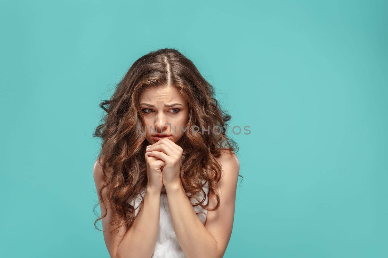 The young woman's portrait with sad emotions at studio