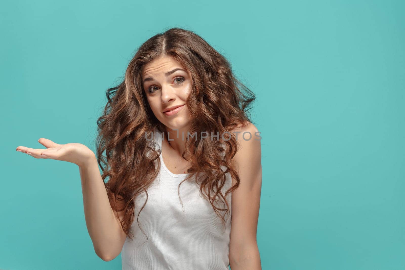 The portrait of alarmed young woman with shocked facial expression Presenting something