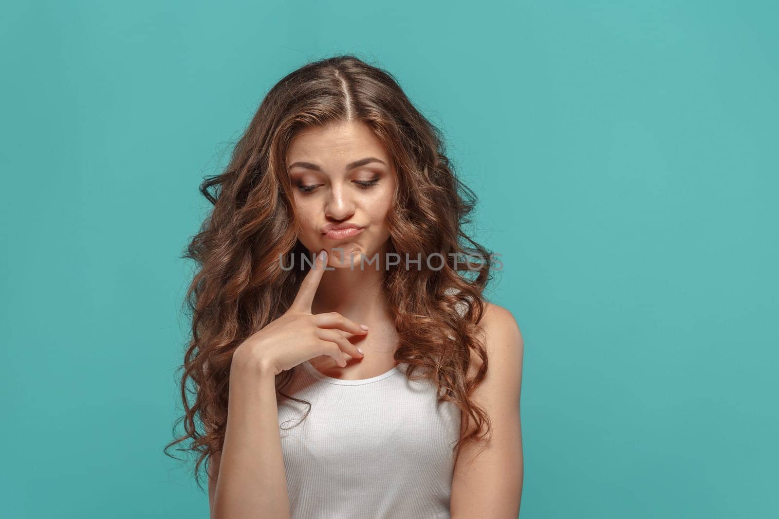 The young woman's portrait with sad emotions at studio