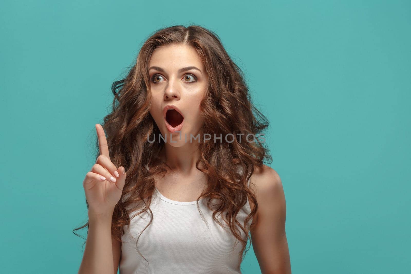 The portrait of alarmed young woman with shocked facial expression