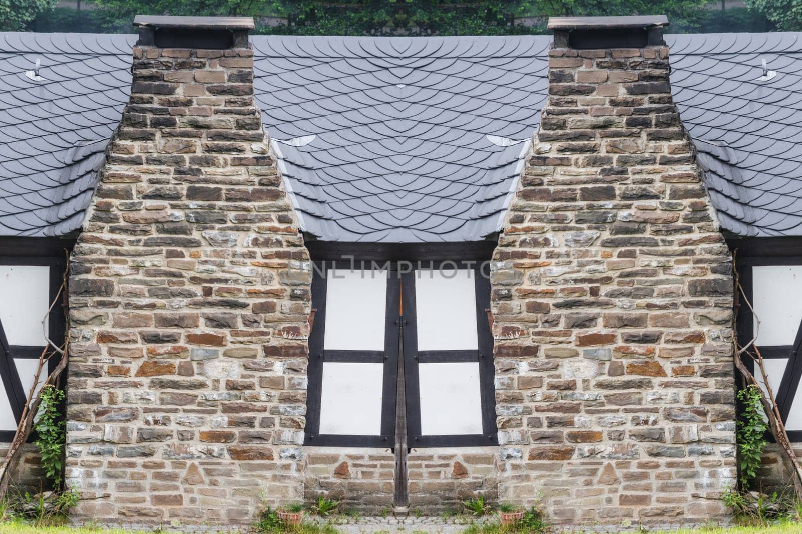 Double chimney made of natural stone and quarry stone..