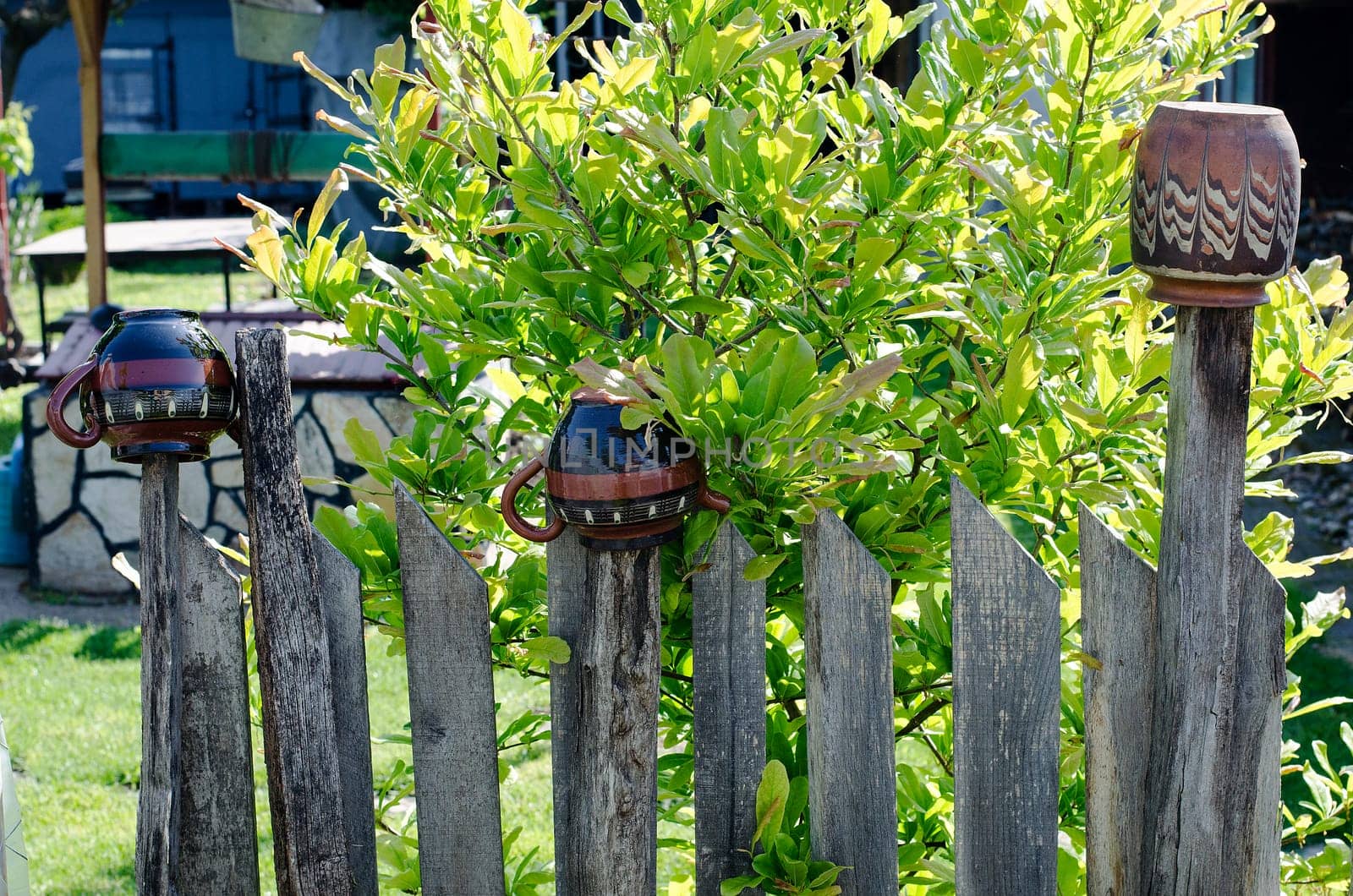 Old wooden fence on green meadow