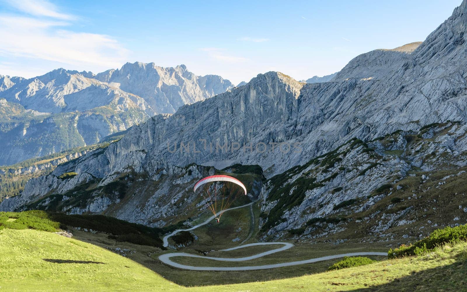 Alpine landscape with soaring paraglider in Bavarian Alps mountains