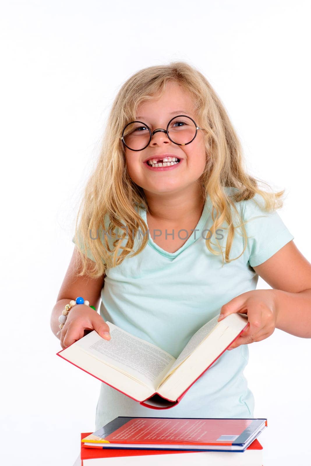 sweet funny girl with pile of books and round glasses