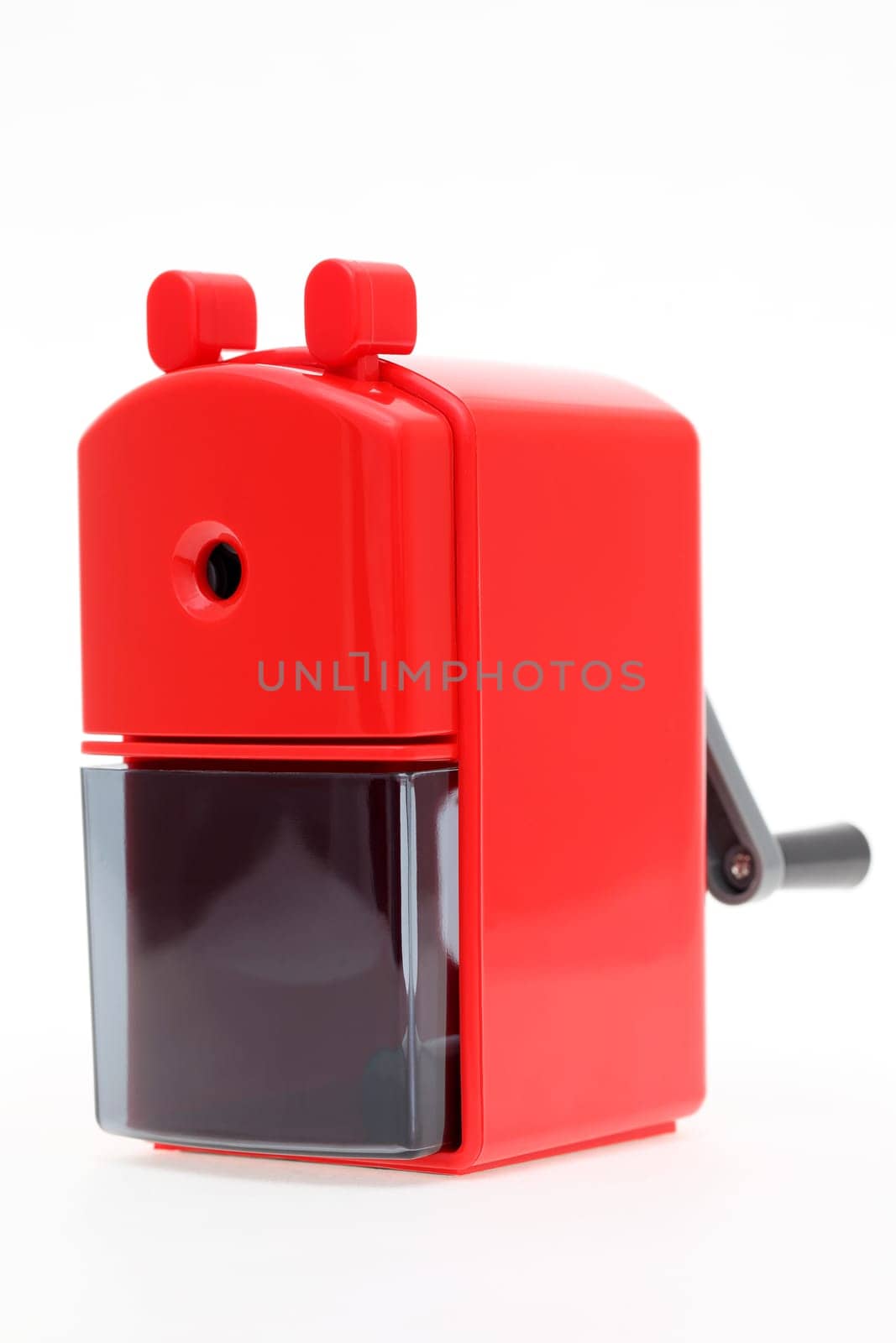 Red plastic pencil sharpener on white background