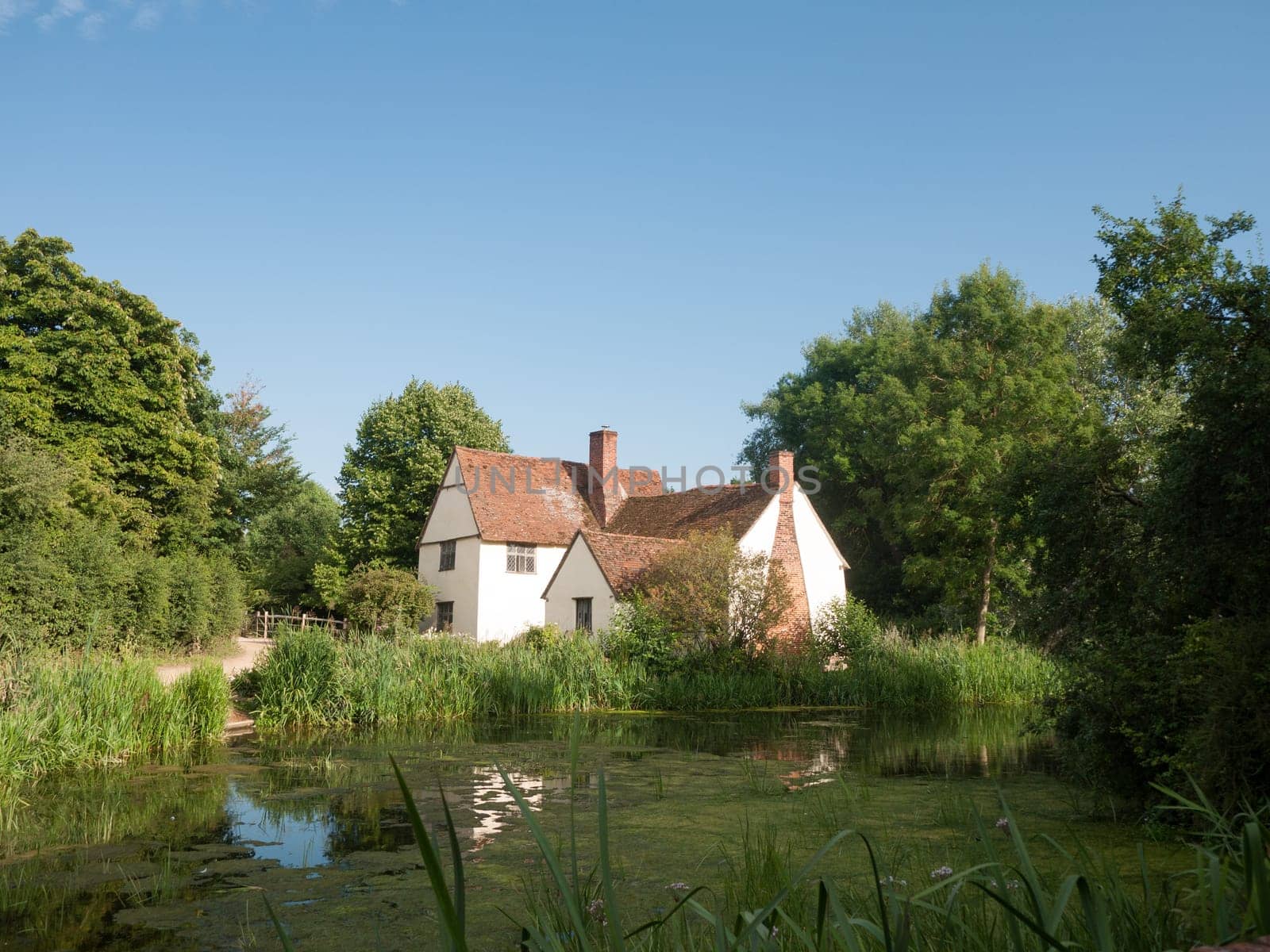 Willy Lotts' cottage and river front on a clear sunny day  Suffolk  UK