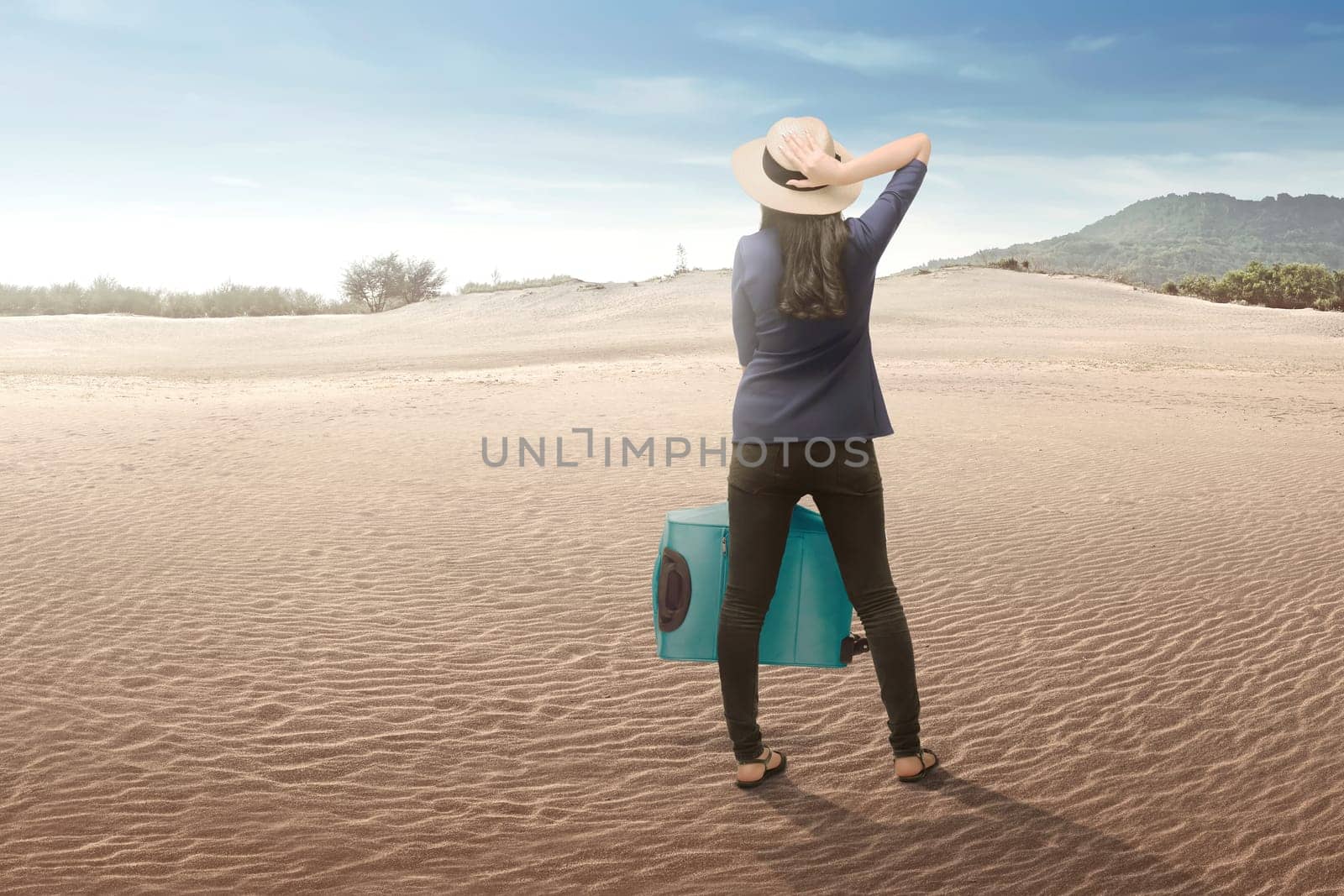 Traveler asian woman enjoying beautiful scenery on sand dune