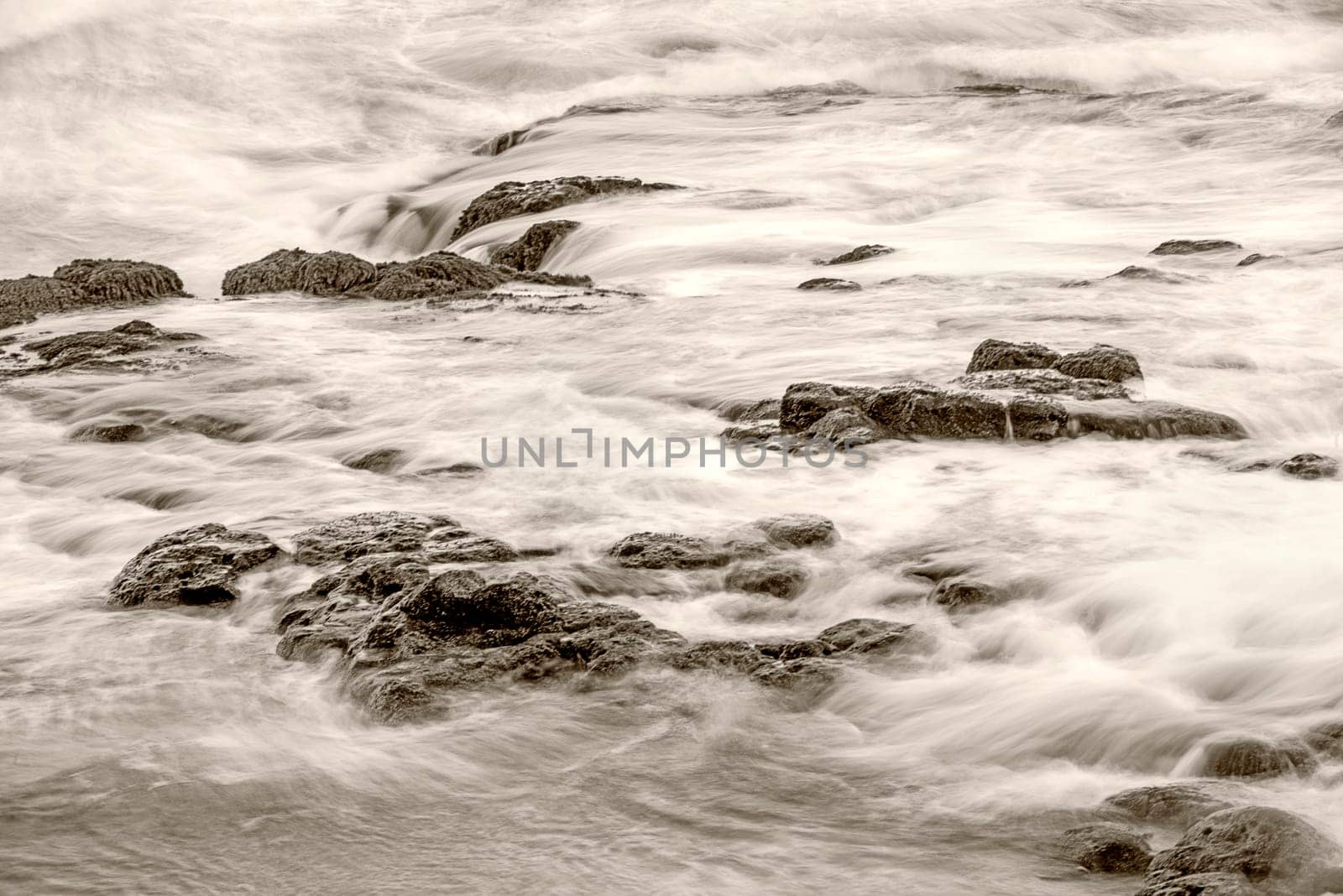 Surf of the Atlantic Ocean with rocks in long exposure