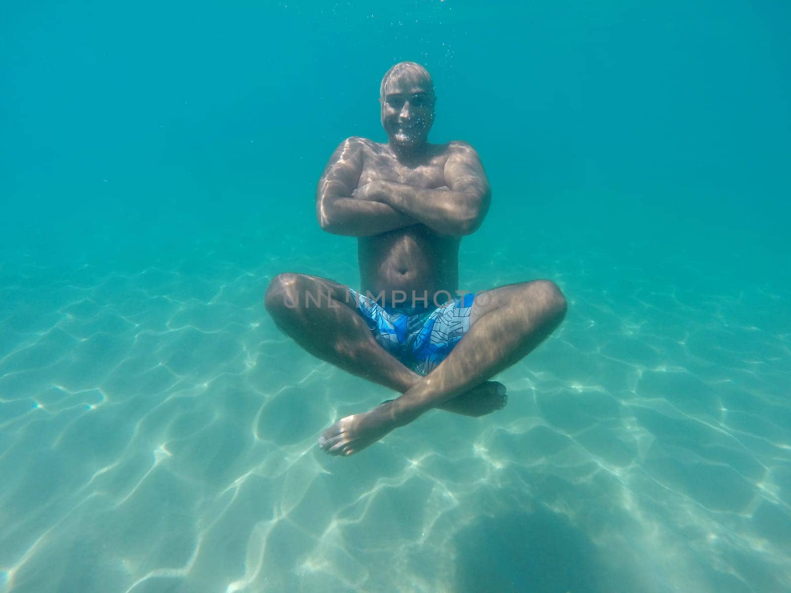 Underwater image of a happy man diving