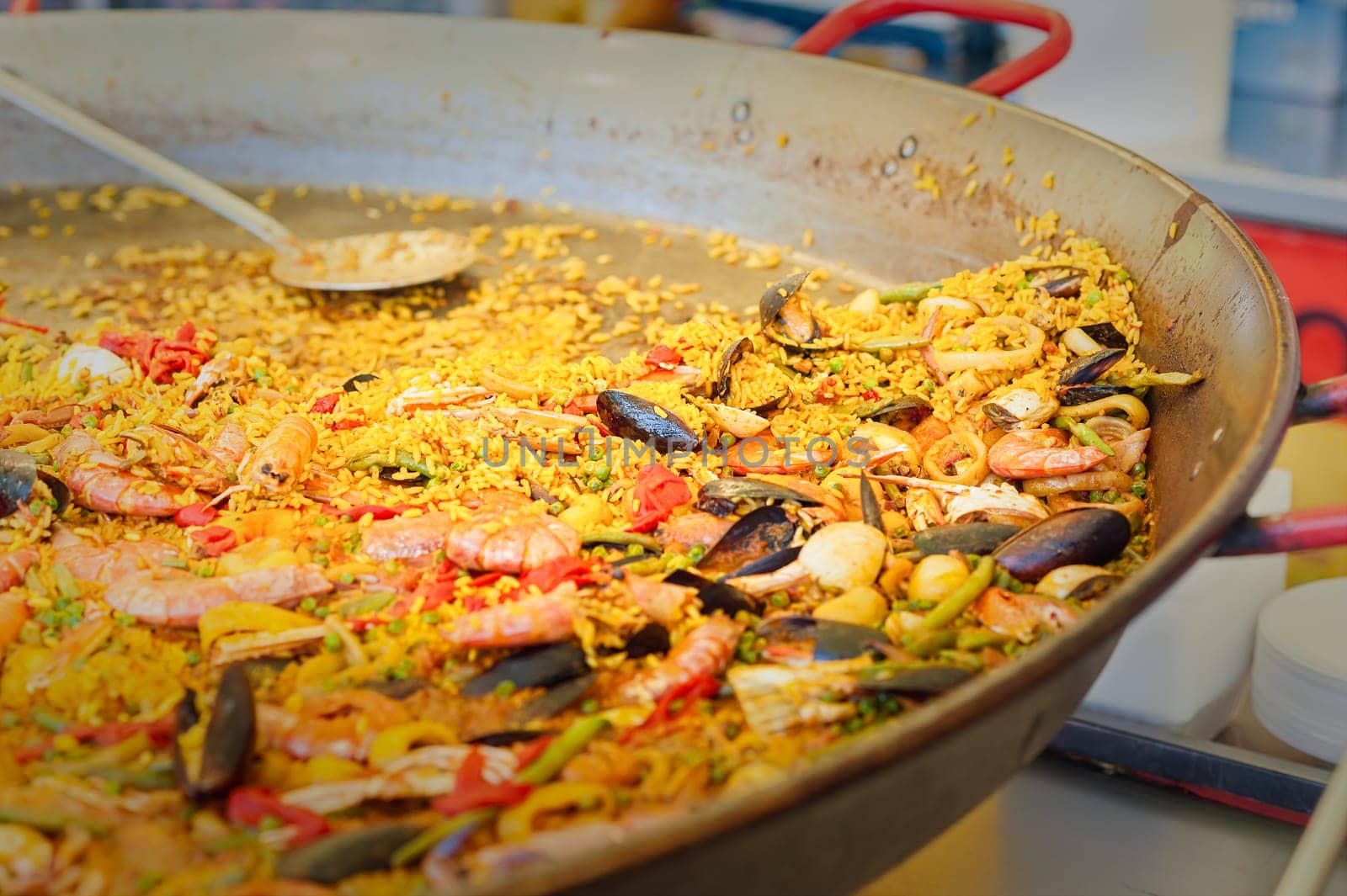 Seafood paella in a paella pan at a street food market  Traditional Spanish paella with seafood and chicken.