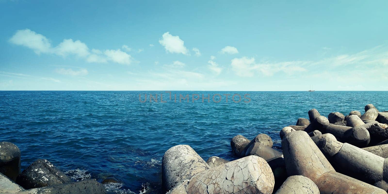 Huge artificial stones in the sea near the harbor at Balchik city, Bulgaria. Summer vacation background. Journey and recreation concept