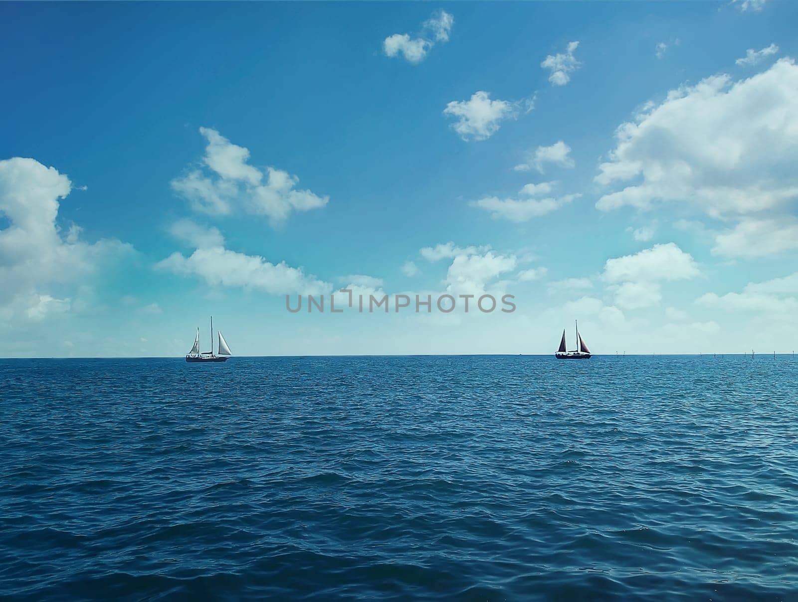 Two ships floating on the ocean in a sunny day