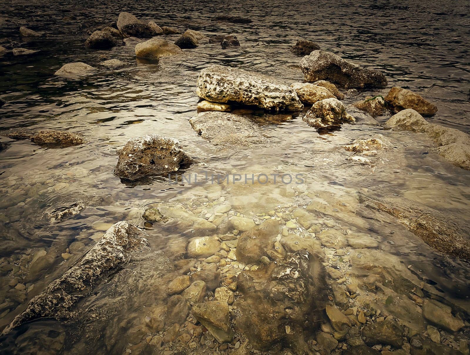 Underwater texture of a rocky seafloor with stone pieces