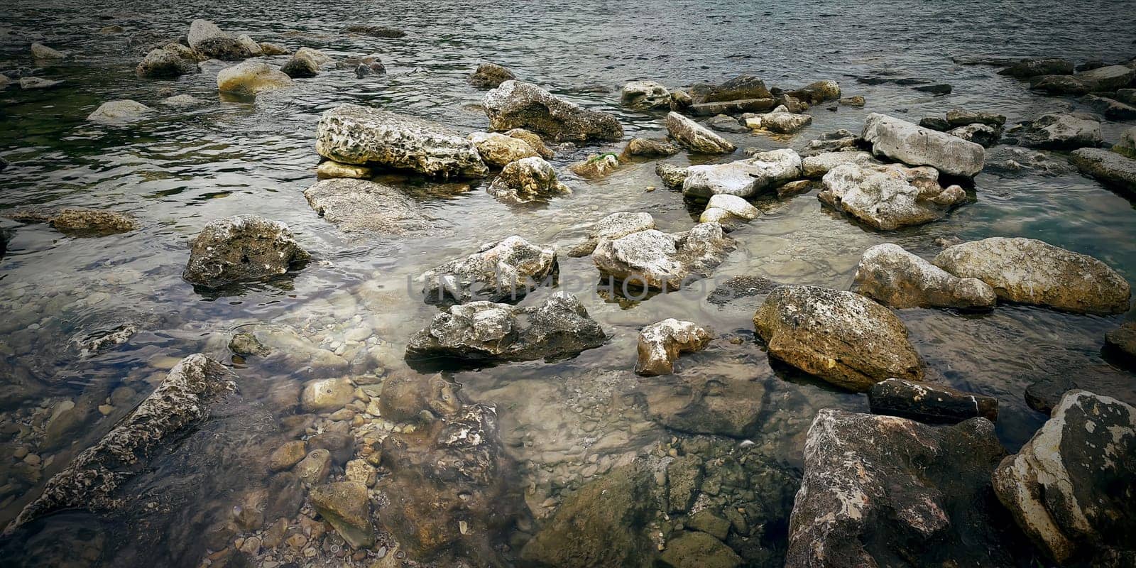 Underwater texture of a rocky seafloor with stone pieces