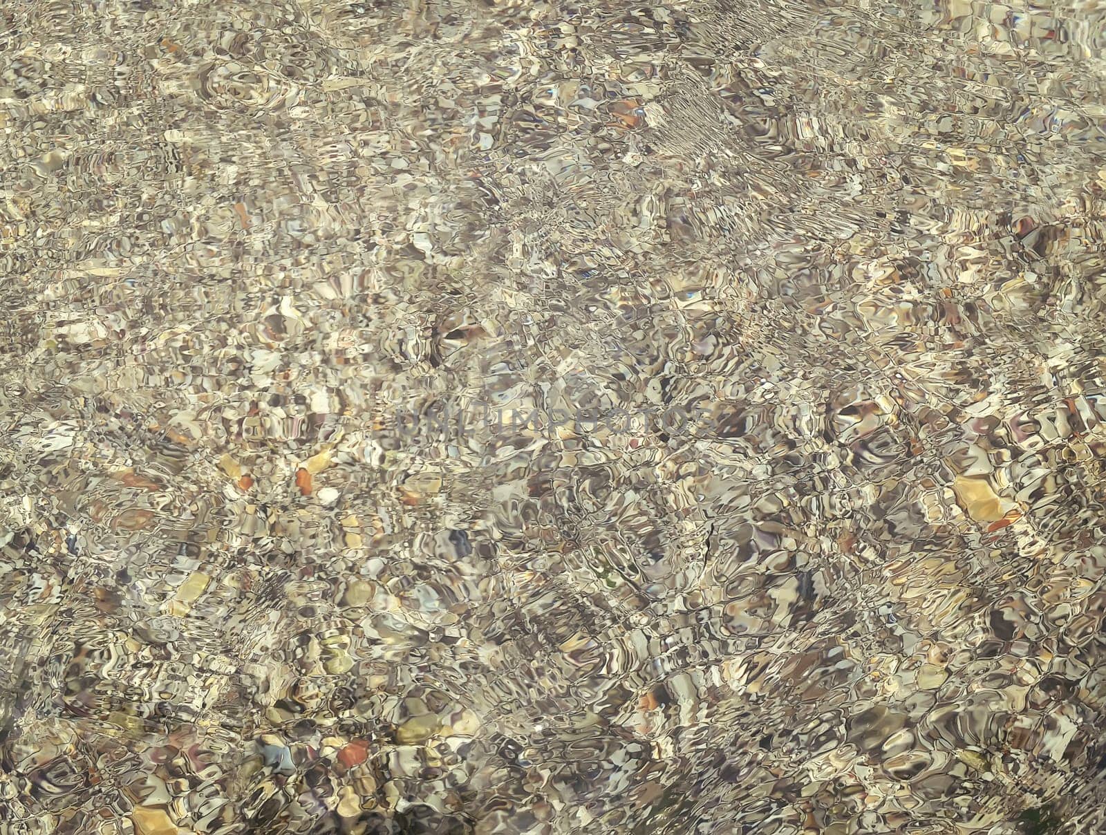 Underwater texture with the light on a rocky seafloor