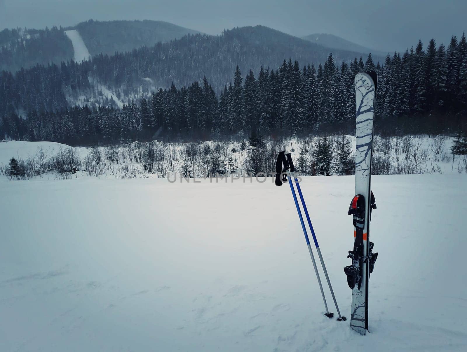 Winter mountains and ski equipment in the snow. Skiing resort winter holidays in Carpathians, Bukovel, Ukraine.