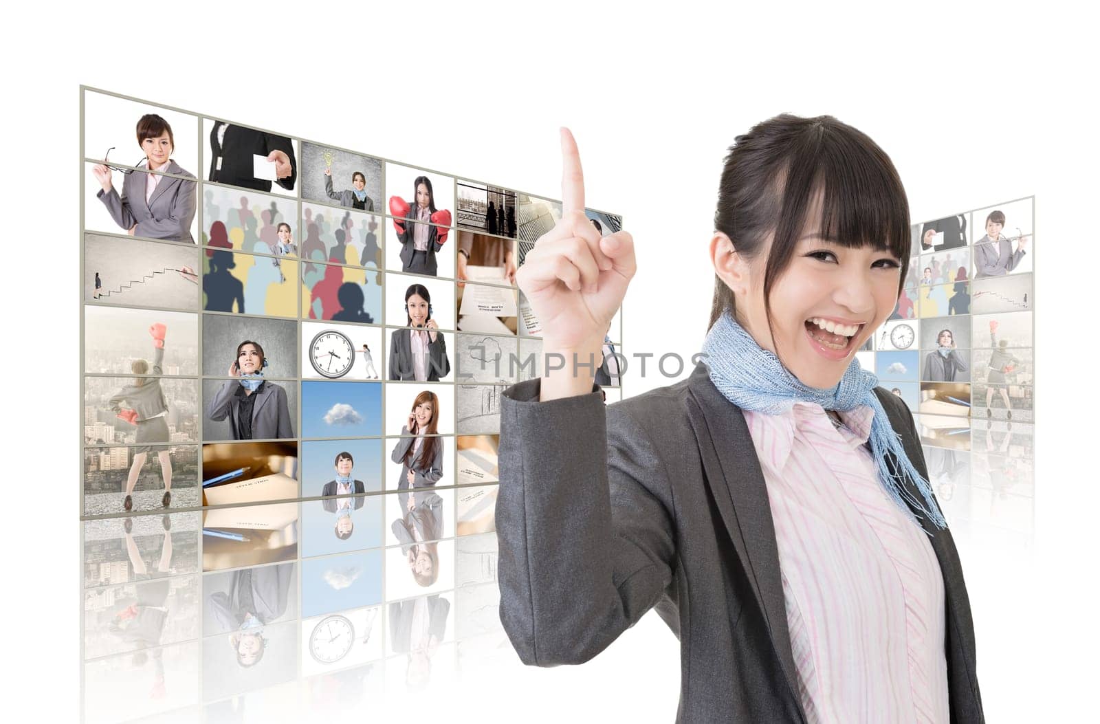 Cheerful Asian business woman standing in front of TV screen wall.