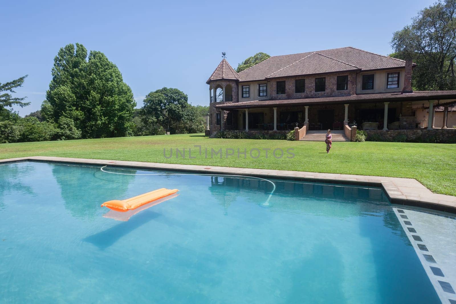 Summer day young girl swimming pool at  private home