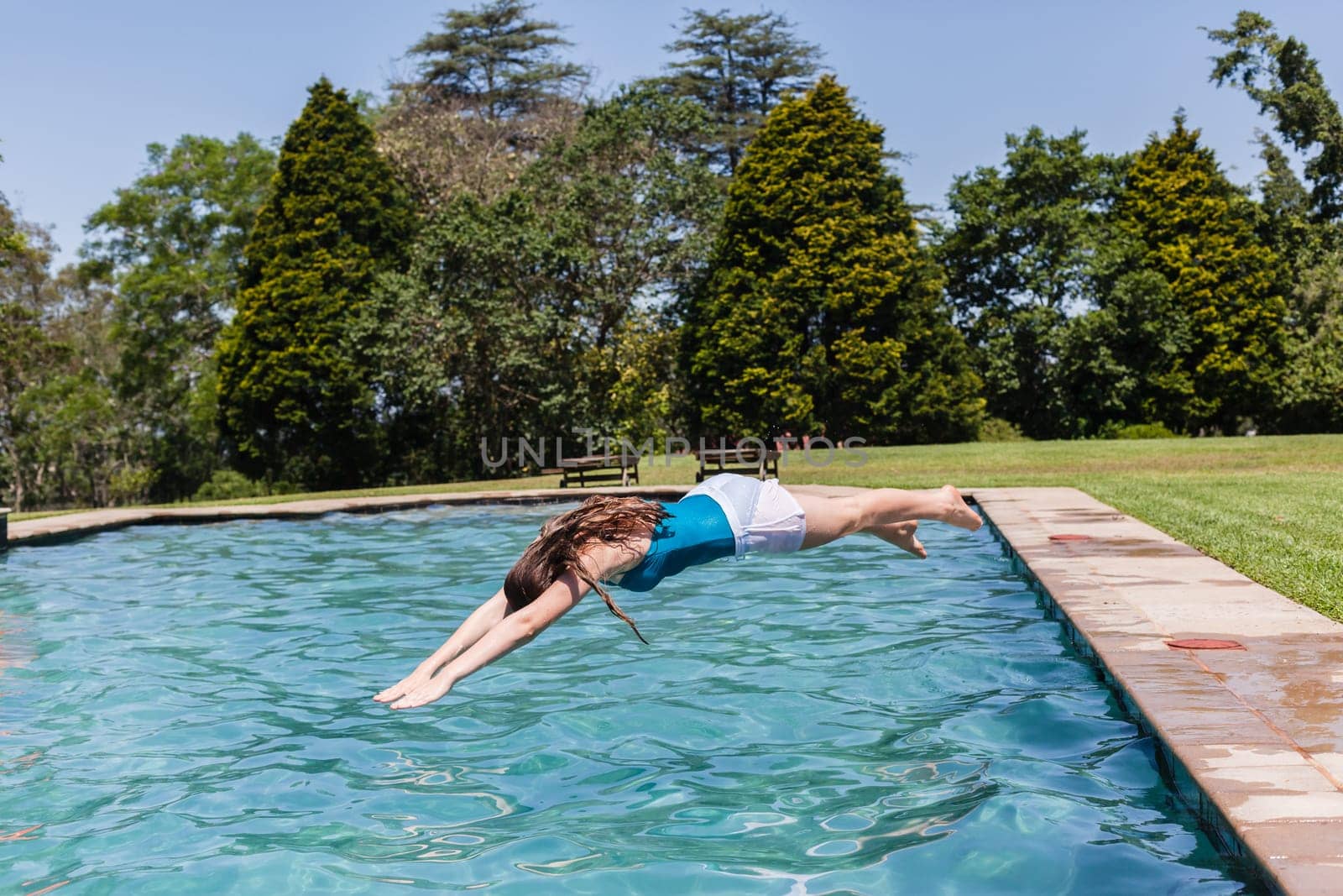 Girl diving home swimming pool summer playtime