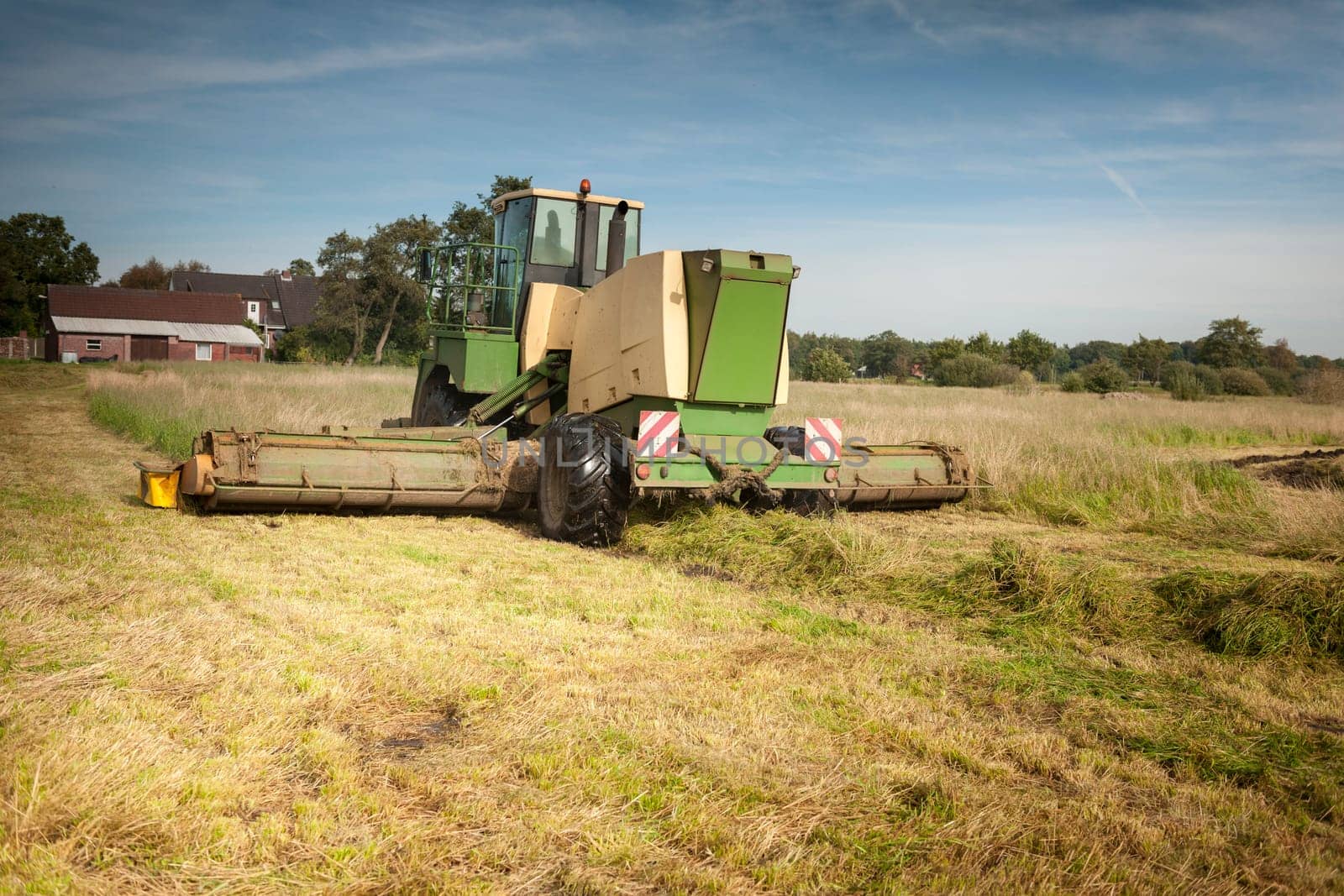 Lifting machine at work in a field in East Frisia.