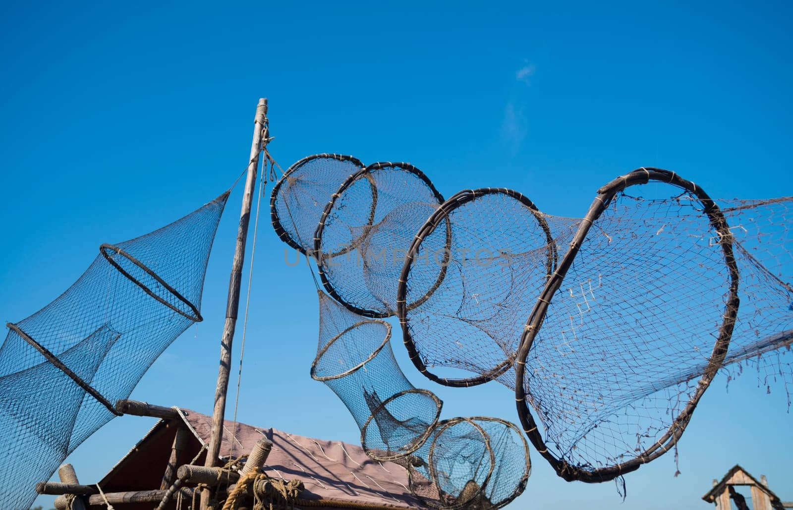 eel fishing nets against a blue sky