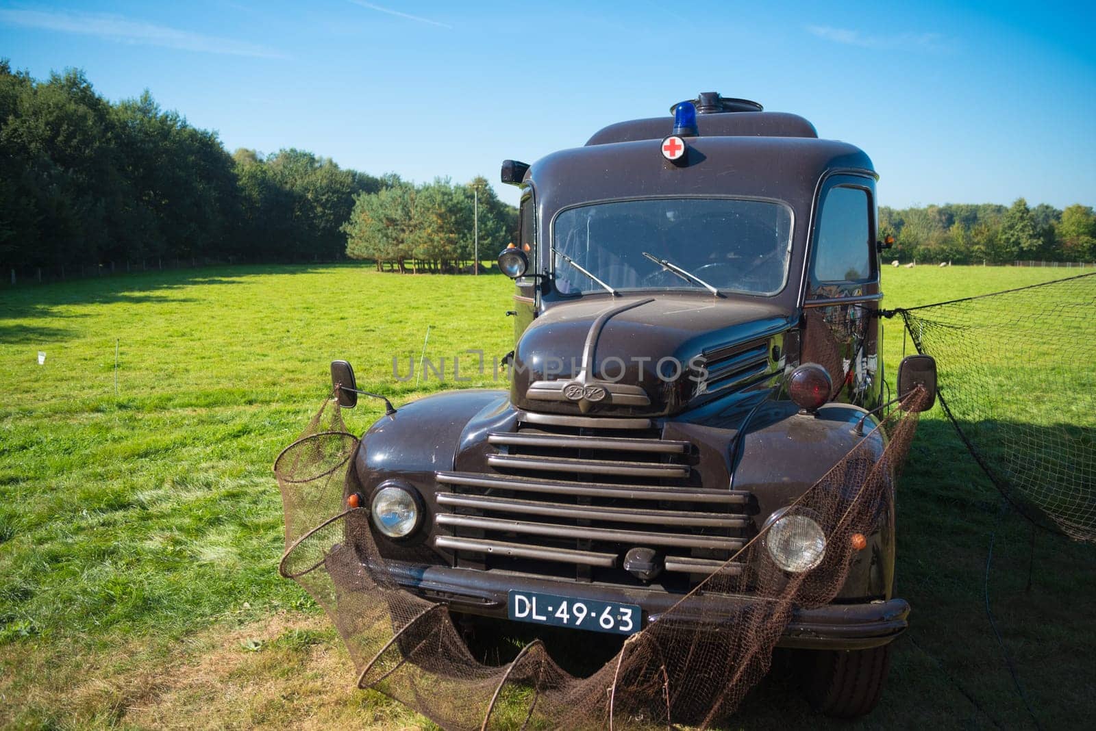 DENEKAMP, NETHERLANDS - SEPTEMBER 25, 2016: Vintage Ford koeln ambulance truck decorated with fishing nets