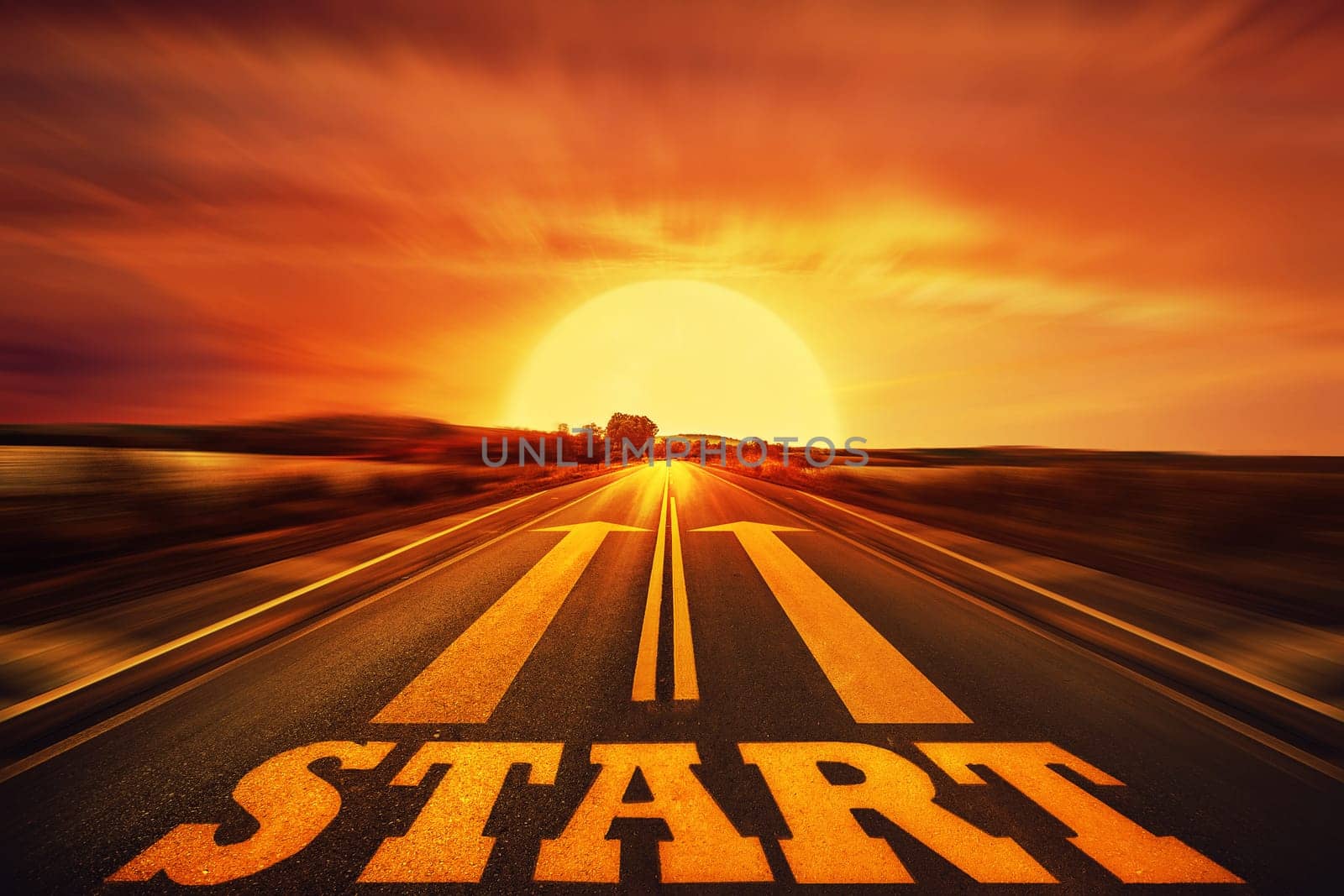 Word Start written on an asphalt road and two arrows as motivation. Long way ahead as a concept of start straight for business.