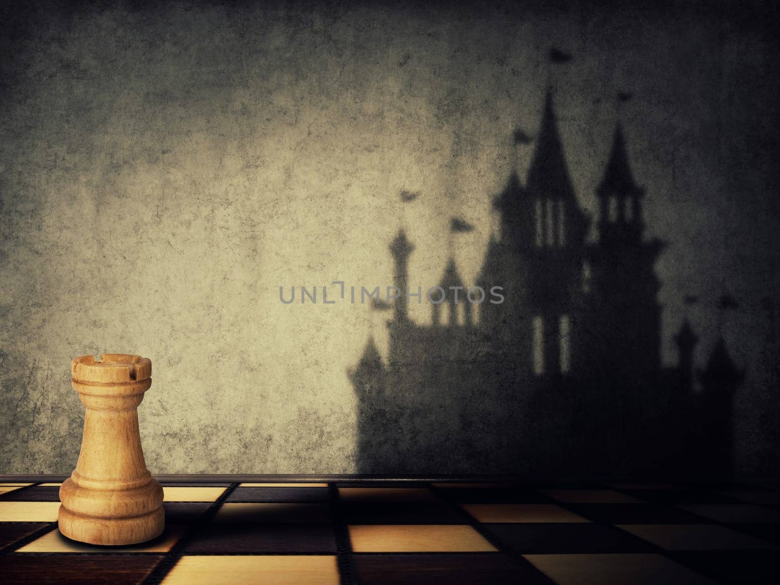 Rook chess piece casting a shadow in shape of a castle on a concrete wall. Business aspirations. Magical transformation.