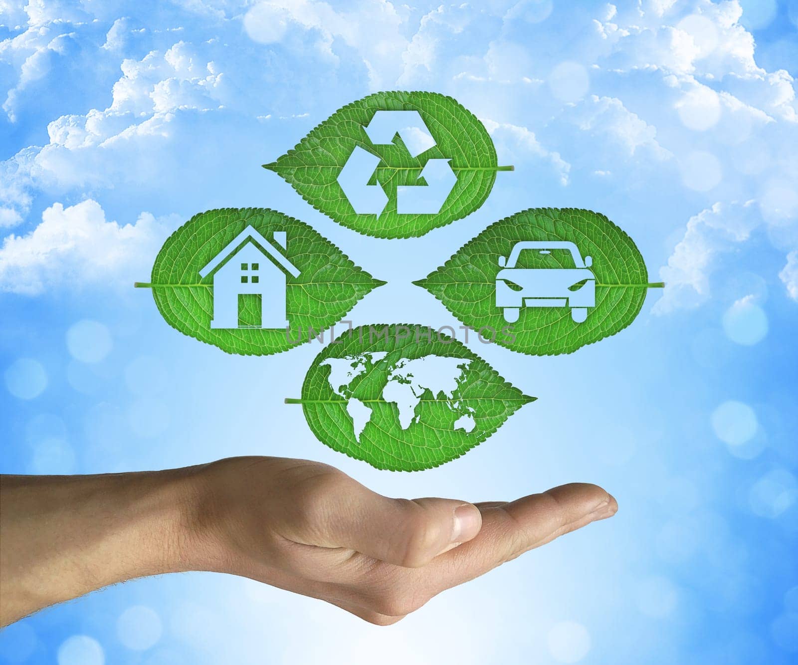 Opened hand holding a green leaf with recycling symbol on a blue sky background. Friendly environment and sustainable development and eco world concept