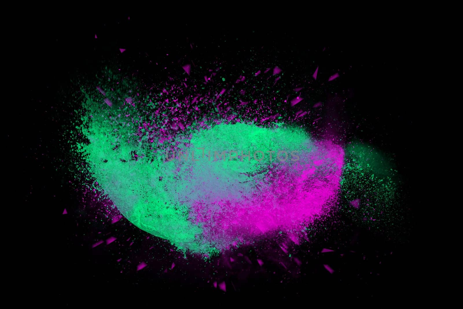 Freeze motion of colorful powder paint exploding isolated on black dark background. Abstract design of color dust cloud. Particles explosion screen saver, wallpaper, brush
