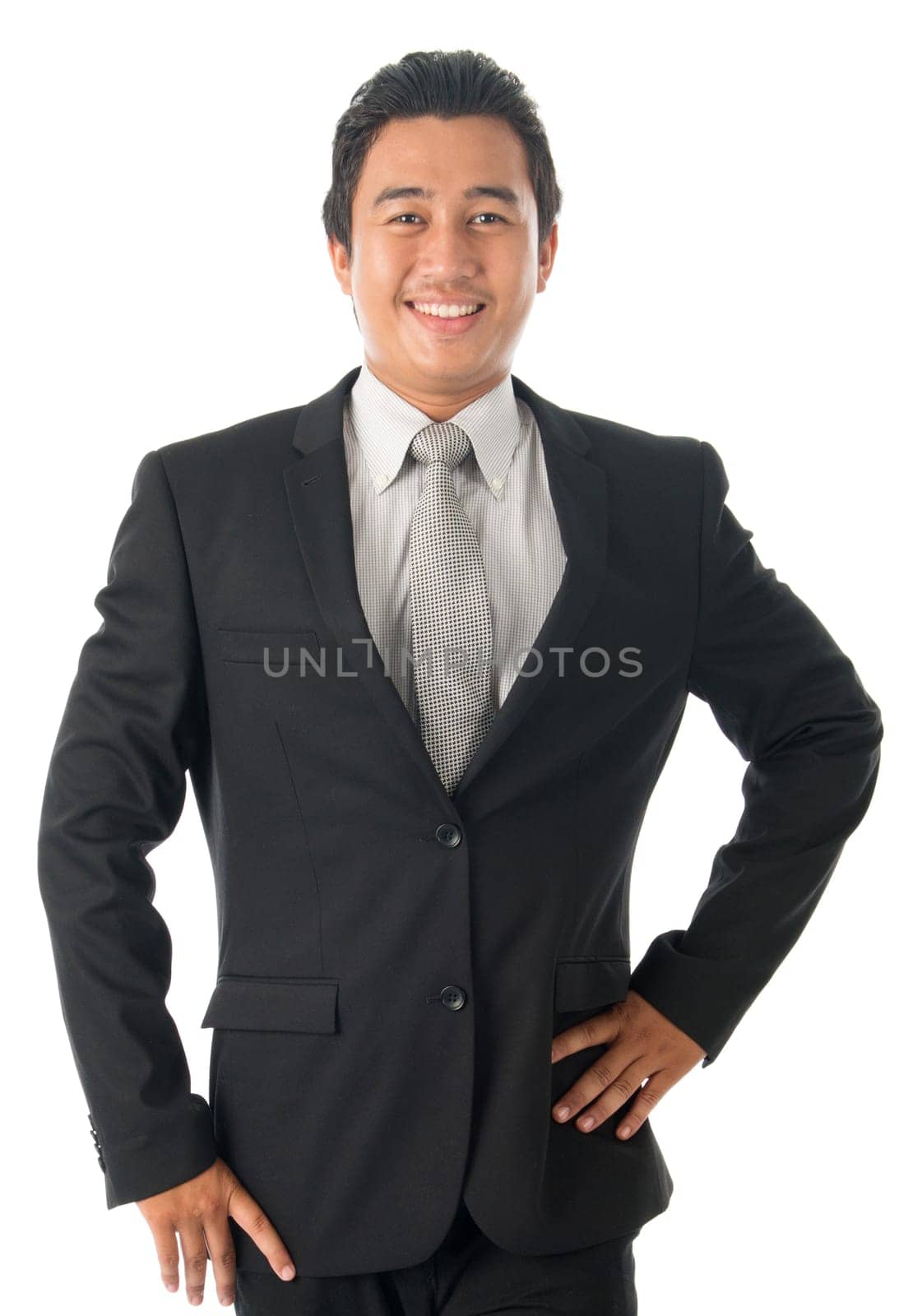 Portrait of happy young Southeast Asian businessman standing isolated on white background.