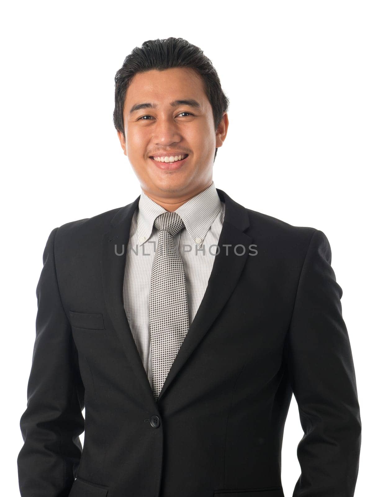 Portrait of good looking young Southeast Asian businessman standing isolated on white background.