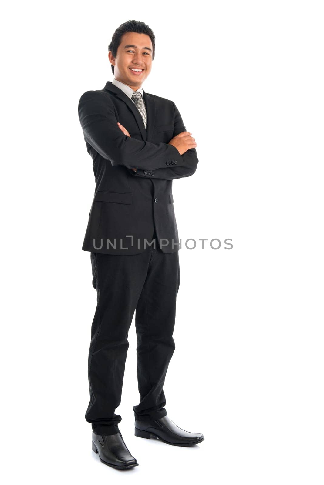 Full body attractive young Southeast Asian businessman arms folded standing isolated on white background. Asian malay male model.