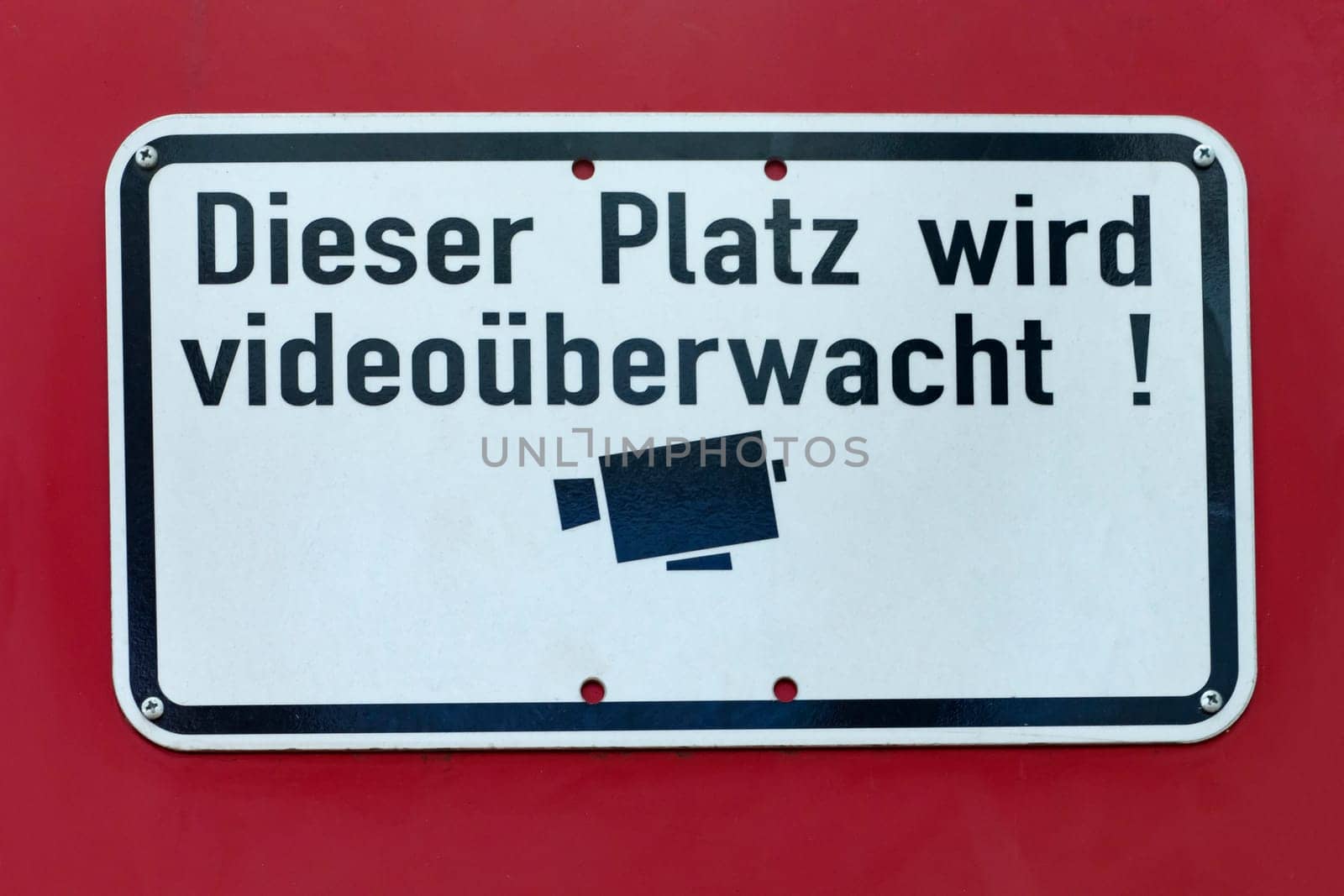 Video monitoring sign on a red background