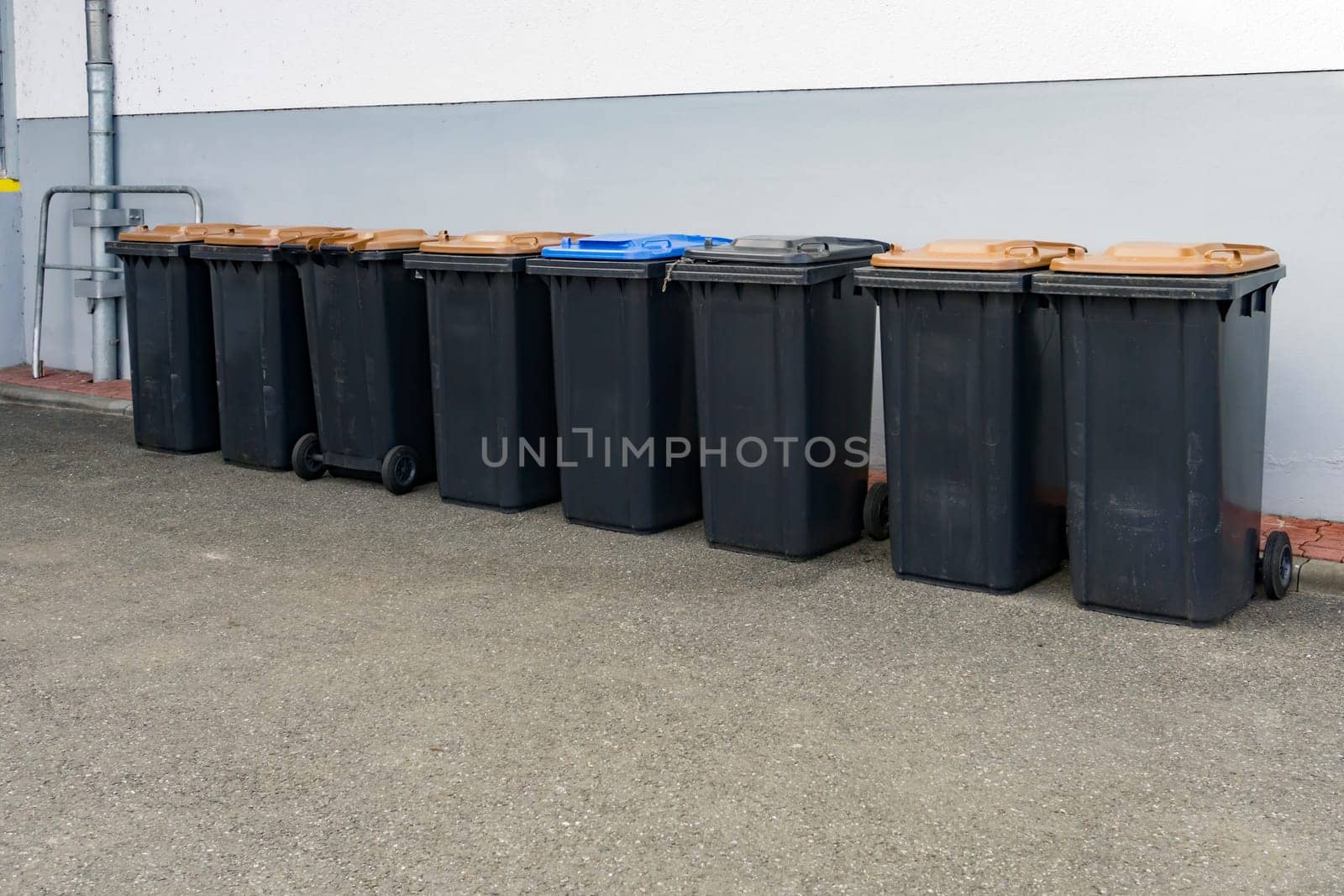 Grey garbage cans in a row