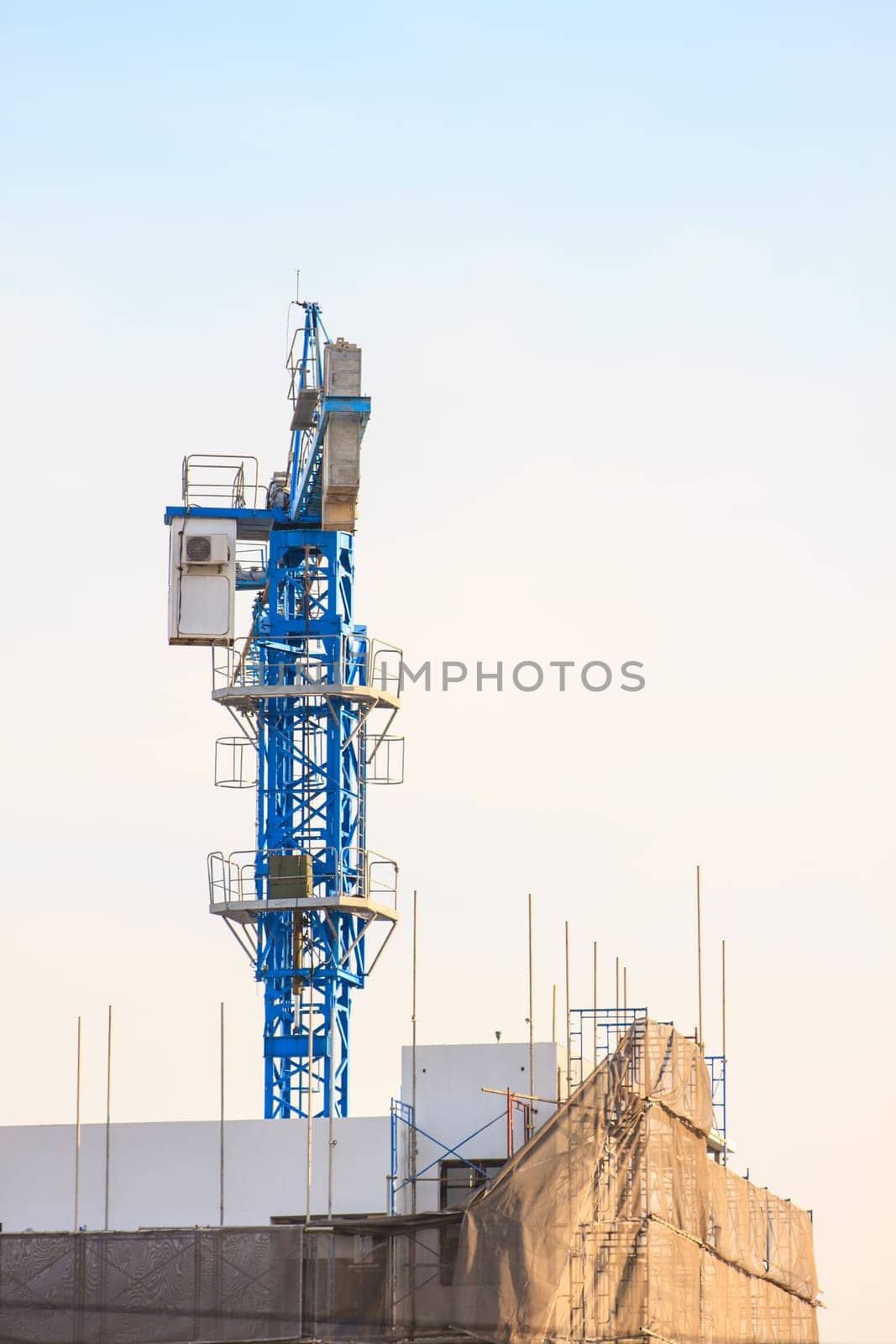 Construction site with cranes on sky background