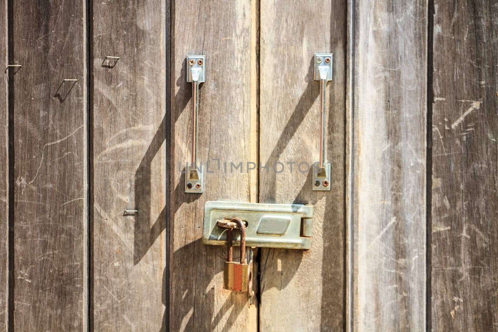 Padlock on wooden background, pad lock secures an old door